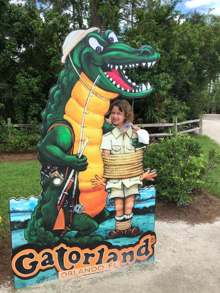 Posing at the welcome sign at Gatorland, Orlando, Florida.